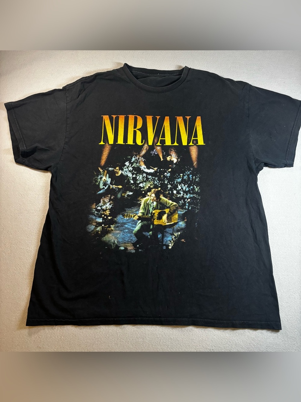 NIRVANA Black Tee with Yellow-Orange Logo and Concert Graphic